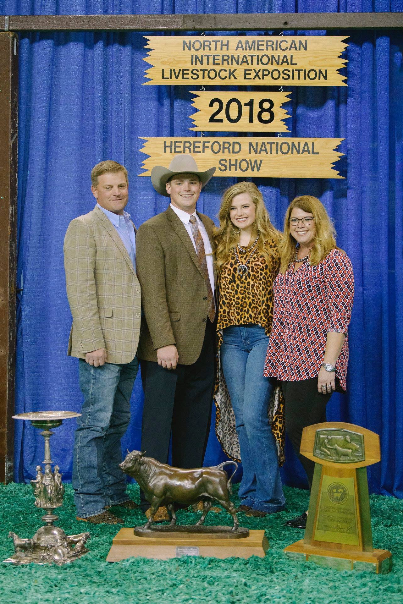photo of four people with awards